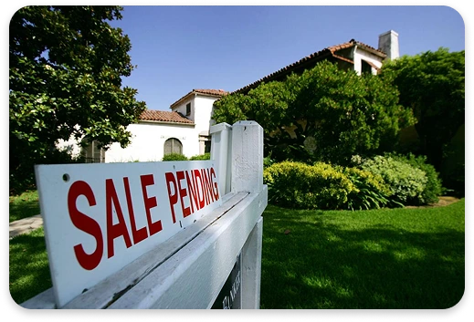Home for sale sign in front of a house